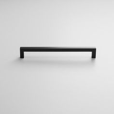 a black shelf sitting on top of a white wall