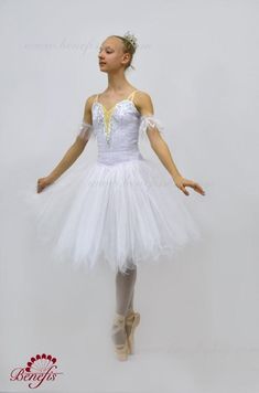 A white Degas (knee length) tutu for the role of the Snow Flake in the ballet The Nutcracker. The bodice of this tutu is made with white shiny brocade and fastens in the back with a double row of hooks and eyes. The bodice features a deep V neck with a nude insert. Decorations are made with silver appliques, crystals and sequins, while little crystals are sewn onto the nude insert. Arm bands included. Head piece NOT included. The 5 layers, soft net white tutu skirt has scalloped edges and ruffle White Ballet Tutu Dress For Party, Fitted White Tutu Dress For Costume Party, White Tulle Tutu Dress For Debutante Ball, White Fitted Tutu Dress For Costume, Fitted White Tutu Dress With Tulle Skirt, White Fitted Tutu Dress With Tulle Skirt, White Fitted Tutu Dress, Sugar Plum Nutcracker, Ballet The Nutcracker