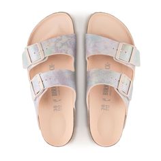 The Arizona Vegan Slide Sandal in Iridescent Light Rose from Birkenstock. The BIRKENSTOCK Arizona is a real classic that has been inspiring men and women with its timeless design for decades. This variant has an iridescent silky sheen and sparkles in rainbow colors. The tonal details complete the shoe's sophisticated appearance. The upper is made of skin-friendly microfiber. Anatomically shaped cork-latex footbed Upper material: microfiber Insole: microfiber Sole: EVA Details: two straps, each w Iridescent Light, Birkenstock Styles, Vegan Sandals, Birkenstock Women, Calf Muscles, Light Rose, French Brands, Rose Lights, Birkenstock Arizona