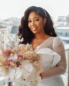 a woman holding a bouquet of flowers in her hands