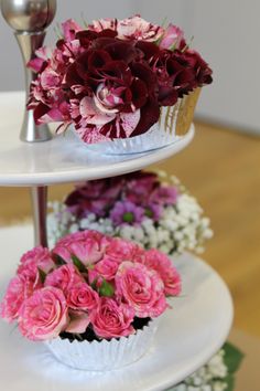 three tiered trays with flowers on them