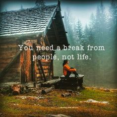 a person sitting on a bench in front of a cabin with the words you need a break from people, not life