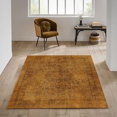 an old rug in the middle of a room next to a chair and table with a lamp on it