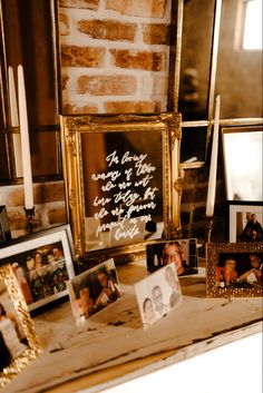 a table topped with pictures and framed photos