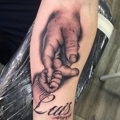 a tattoo on the arm of a person holding hands