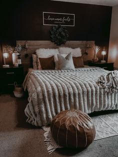 a bedroom with a large bed and pillows on the floor