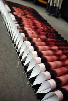 many different shades of lipstick are lined up in the same row and one is empty