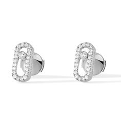 With an elegant and pared down style, these 18k white gold pave diamond earrings set with a brilliant cut diamond are part of the Move jewelry for women collection. Easy to wear everyday in white gold, these diamond earrings suit to any style, from the most casual to the sophisticated ones. This pair of Move Uno white gold diamond stud earrings will become your day to day fetish jewel. Diamonds are 1/5ctw, G in color, and VS in clarity. Messika Style #: 05634-WG Messika Earrings, Messika Move Uno, White Gold Diamond Earrings, Pave Diamond Earrings, Gold Diamond Earrings Studs, Gold Diamond Studs, White Gold Earrings Studs, Gold Diamond Earrings, Diamond Stud Earrings