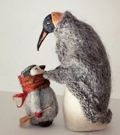 there is a stuffed penguin and a small animal