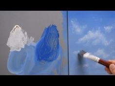 someone is painting the sky with blue and white paint