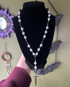 This necklaces is edgy/grunge style inspired, with a funky and groovy twist. Necklace is made with matte white glass beads, black glass beads, metal sword charm, and a lobster claw closure. Necklace is about 20 inches long. Necklace is not elastic/stretchy. While this is made attentively, please handle with care. Long Beaded Necklace Ideas, Necklace Inspo Beads, Funky Jewelry Necklaces, Grunge Necklaces, Edgy Grunge Style, Twist Necklace, Edgy Grunge, Wire Wrap Jewelry Designs, 20 Inch Necklace