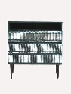 a black and white sideboard with an intricate design on the front, against a white background