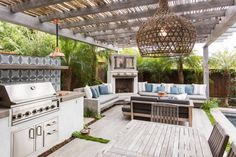 an outdoor kitchen and dining area with wood flooring