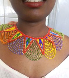 African wedding necklace, Zulu necklace, Beaded shawl necklace, African jewelry, Masai necklace, Bridesmaid necklace, Wedding gift This stunning necklace is superbly crafted with fine beads. The necklace can be worn with any outfit at different occasions and it will absolutely makes you stand out. 100% handmade using fine beads. Closure: ball joint Color: multicolor 3-5 days delivery via DHL Express The shipping fee is for the first item only and additional necklaces or items ship for free. Whol Zulu Attire, Masai Necklace, Zulu Necklace, Beaded Shawl, Bead Dress, African Beads Necklace, Beaded Boho Necklace, Necklace African, African Necklace