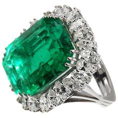 Magnificent Natural Colombian Emerald, weighing approximately 25 carats, set in a custom hand crafted 18 karat white gold mounting. Triple prong set at each corner secure this center gem and it is surrounded by 25 marquise cut and pear shape bright, white diamonds, with a total approximate weight of 5 carats which crea Emerald Rings, Diamond Cocktail Ring, Emerald Diamond Ring, Colombian Emeralds, Diamond Cocktail Rings, Antique Engagement, Antique Engagement Rings, Emerald Jewelry, Pretty Rings