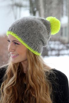 a woman with long hair wearing a knitted hat