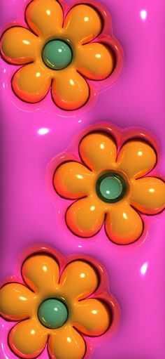 two orange and green flowers floating on top of each other