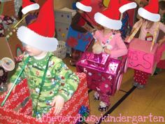 children in santa hats are riding on small toy cars at the christmas party with gifts