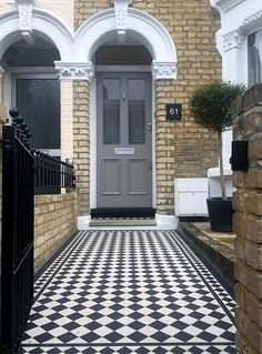 a black and white checkered floor in front of a house