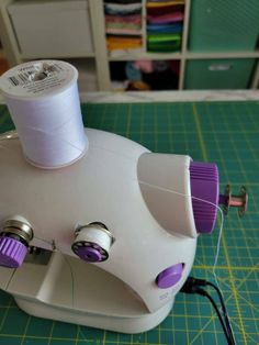 the sewing machine has two spools of thread on it's top and is ready to be sewn