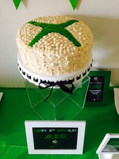 a cake on a table with green and white decorations