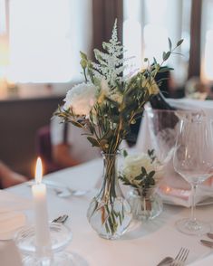 a vase filled with white flowers sitting on top of a table