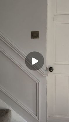 a white door with a black handle on it and some stairs in front of it