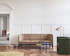 a living room filled with furniture and a wooden floor