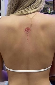 a woman with a rose tattoo on her back