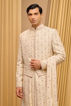 Ivory sherwani, hand embroidered using gold zari and threadwork, accentuated with sequins and French knots. Comes with an embroidered stole, kamarbandh and kurta. Paired with a churidar, safa and jutti fabric. - Aza Fashions Designer Bandhgala With Dupatta For Reception, Designer Cream Traditional Wear For Diwali, Ceremonial Cream Bandhgala With Cutdana, Designer Cream Traditional Wear With Chikankari Embroidery, Designer Cream Sets With Cutdana, Cream Bollywood Nehru Jacket For Reception, Cream Nehru Jacket With Naqshi For Reception, Designer Sherwani With Dupatta For Reception, Designer Cutdana Sherwani For Reception