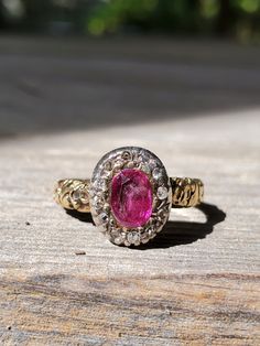 1770-1780 Georgian natural ruby and diamond ring in 18k with a silver top and rose cut diamonds.   The deeply chased band is indicative of the late 18th century, as well as the portrait style bezel.  A lot of cameos in the 1770s/80s have this style of bezel.The ruby is 4.6 mm x 6.7 mm. Ruby is pinkish red.  Has not been resized and chasing goes all around ring.  Pics taken with new camera  which most accurately shows how it looks outside in  sunlight.  Ask questions I reply quickly! Shipped with Victorian Ruby Ring With Diamond, Antique Ruby Ring With Single Cut Diamonds, Antique Red Diamond Ring With Rose Cut Diamonds, Antique Ruby Rings With Single Cut Diamonds, Victorian Pink Rose Cut Diamond Jewelry, Antique Pink Rose Cut Diamond Jewelry, Antique Pink Jewelry With Rose Cut Diamonds, Victorian Ruby Ring With Single Cut Diamonds, Victorian Yellow Gold Ruby Ring With Single Cut Diamonds