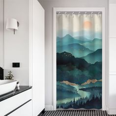 a bathroom with a black and white checkered floor, shower curtain that has a mountain scene on it