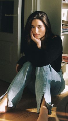 a woman sitting on the floor with her legs crossed