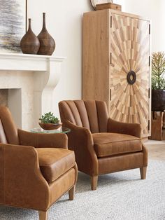 a living room with two chairs and a fireplace