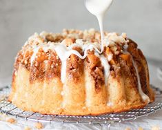 a bundt cake is being drizzled with icing