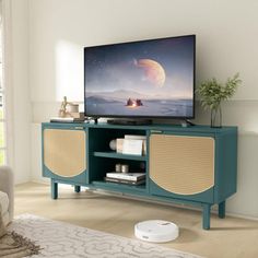 a flat screen tv sitting on top of a wooden cabinet