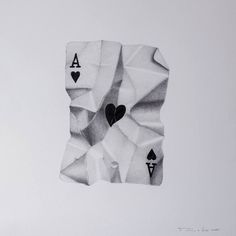 a piece of paper with playing cards cut out of it's sides and two hearts in the middle