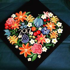 a graduation cap decorated with flowers and the number twenty on it's front side