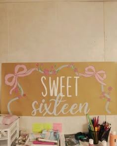 there is a sign that says sweet sixteen on the wall next to other office supplies