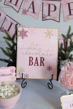 a pink and gold christmas themed dessert bar with hot chocolate, marshmallows