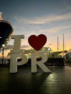 a large sign that says i love pr in front of a boat