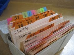 a container filled with lots of folders on top of a table