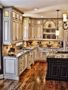 an image of a kitchen with white cabinets and wood flooring on the bottom right hand corner