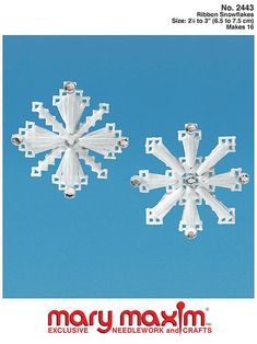 two snowflakes are shown against a blue sky