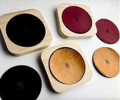 four wooden coasters with different colors on them