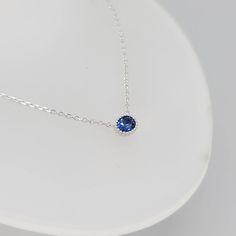 Inspired by Princess Diana’s engagement ring, the Diana Sapphire Necklace boasts a bold, beautiful blue hue uncommon among natural sapphires. Dimensions:Chain length: 40 cm, adjustable up to 42 cm (approx. 15.7 to 16.5 in)Pendant: 6 mm x 5 mm Materials used (pictured):14K solid white gold, 1.73 g1 x natural blue sapphire (heated), 0.45 ct (5 mm x 4 mm) Note: Only the White Gold option is Ready to Ship. Other options can be ordered but standard delivery times apply. Blue Sapphire Birthstone Necklace For Anniversary, Minimalist Blue Necklace For Anniversary, Elegant Blue Sapphire Necklace, Elegant Sapphire Solitaire Jewelry, Fine Jewelry Sapphire Necklace With Lab-created Sapphire, Sapphire Fine Jewelry Birthstone Necklace, Fine Jewelry Sapphire Round Pendant Necklace, White Gold Necklace With Birthstone And Lab-created Sapphire, Sapphire Birthstone Necklace In Lab-created Sapphire