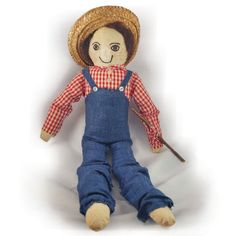 a doll with overalls and a straw hat on it's head is laying down