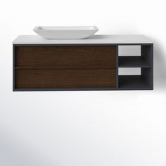 a white sink sitting on top of a wooden cabinet next to a wall mounted faucet