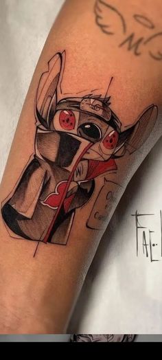 a tattoo on the leg of a person with a red eye and a black hat