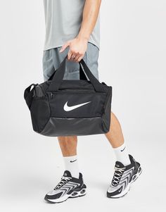 Keep organised with this Brasilia Bag from Nike. In a Black colourway, this bag is made from a light and durable poly fabric that uses at least 50% recycled material. It features a main zippered compartment, a zippered inner compartment to stash sweaty clothes whilst the coated bottom offers lasting wear. With a detachable shoulder strap for custom comfort, it's signed off with the Swoosh to the front. Spot clean. (H: 25.4cm x W: 25.4cm x D: 38.1cm). Nike Air Flight, Nike Windrunner, Nike React Vision, Small Bra, Nike Air Vapormax Plus, Football Socks, Nike Classic, Nike Elite, Nike Tech